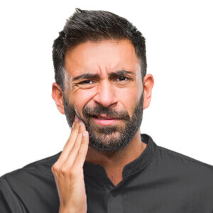 A man holding the right side of his face and grimacing because of a toothache.